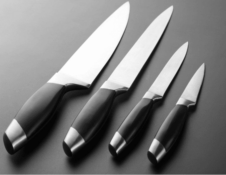 Four identical chef knives of different sizes arranged neatly side by side, featuring black handles on a sleek black background.