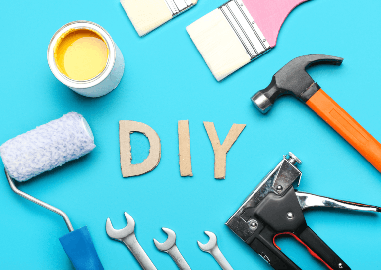 Assortment of DIY tools including a paint roller, hammer, paint tray, three wrenches, a brush, and a small tool arranged around the word 'DIY.