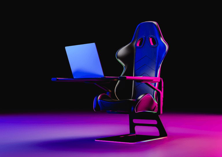 Gaming chair with an integrated table holding a laptop, viewed from a diagonal front angle, featuring a black and red light background.