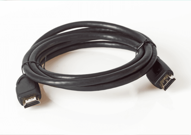 Rolled HDMI cable with a visible connector at the end, resting on a white background, showcasing its versatility and design.