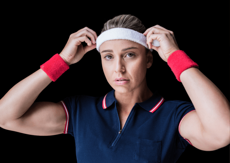 Young woman with her hair pulled back, wearing a blue sport polo shirt with a zipper and sweatbands on her wrists and forehead, adjusting the sweatband on her head.