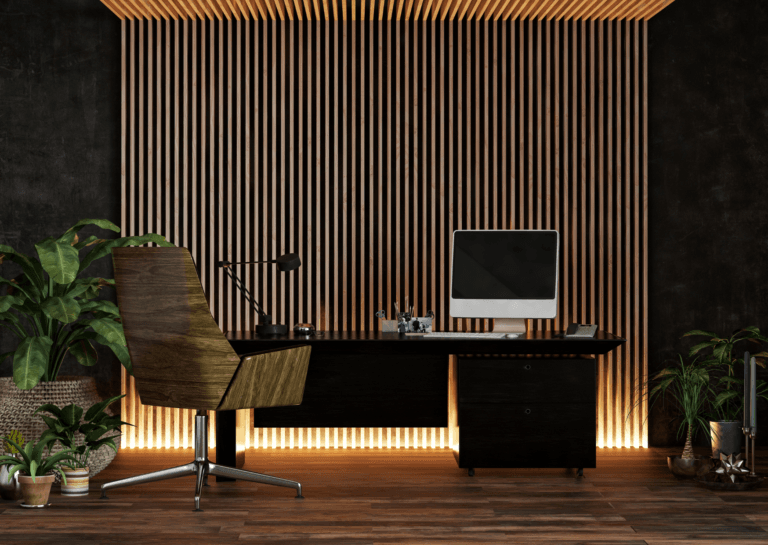 Home office decor featuring vertical illuminated wall panels, a desk with a computer, and a standing plant on the left.