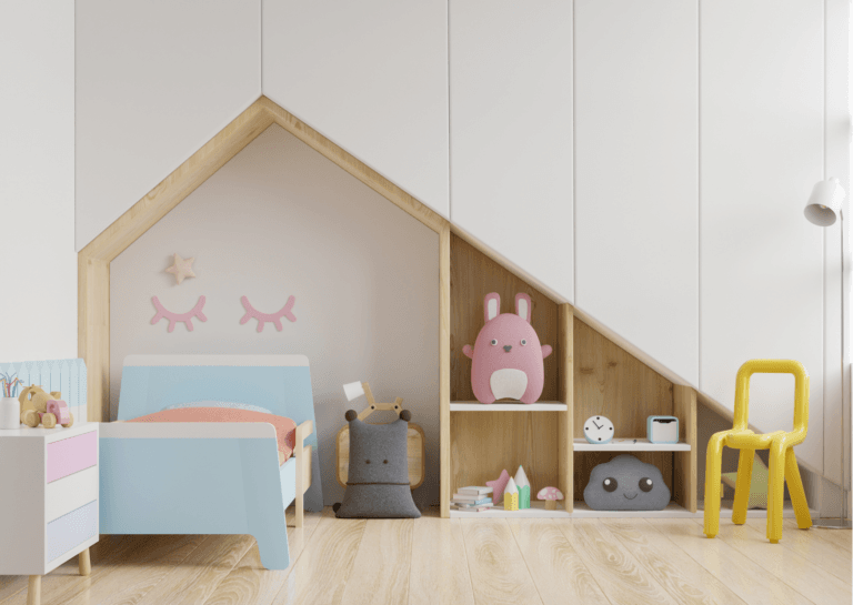 A cheerful bedroom featuring a blue single bed with a drawing of closed eyes above it. Beside the bed is a colorful nightstand, and there’s a built-in cabinet with shelves shaped like a house with a slanted roof, adding a whimsical touch to the space.