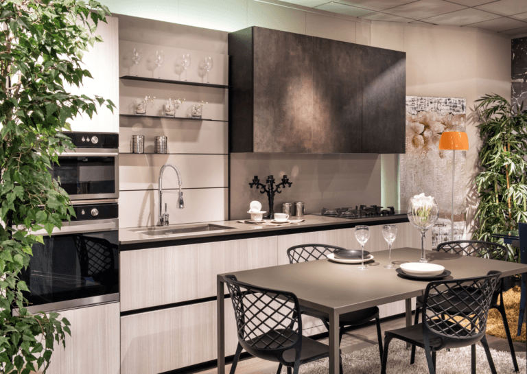 Modern kitchen setup with a white kitchen counter and dark gray dining table in a sleek, minimalist style.