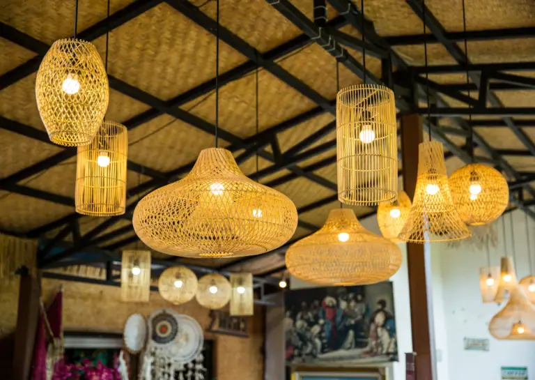 Multiple pendant lights hanging from a sloped ceiling, featuring oval and spherical transparent designs with lights turned on.