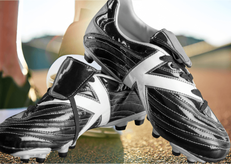 Close-up of new black and white soccer shoes positioned at an angle, showcasing their sleek design and detailing.