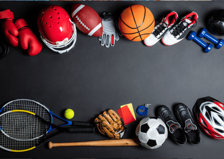 A variety of sports items arranged along the top and bottom of the photo, including boxing gloves, a rugby helmet, a rugby ball, a basketball, weights, a tennis racket and ball, a baseball bat, a baseball glove, yellow and red cards, a soccer ball, soccer shoes, and a bike helmet.