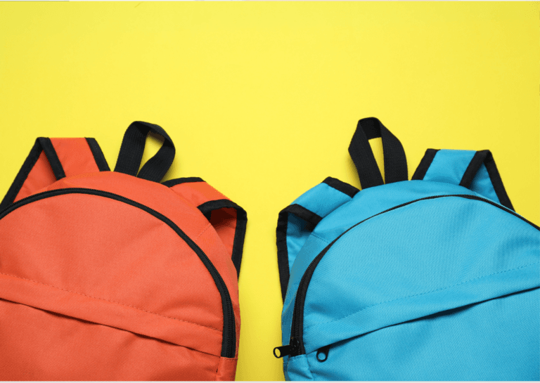 Orange and blue backpack placed against a yellow background, highlighting its vibrant colors and simple design.