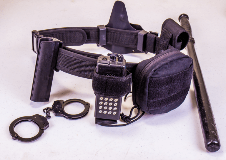 Purple utility belt equipped with a baton, handcuffs, and a walkie-talkie, showcasing a practical and stylish accessory for law enforcement or security.