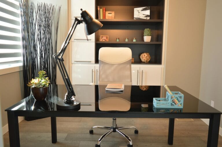 Black study lamp on a black table in a beautifully designed home office.