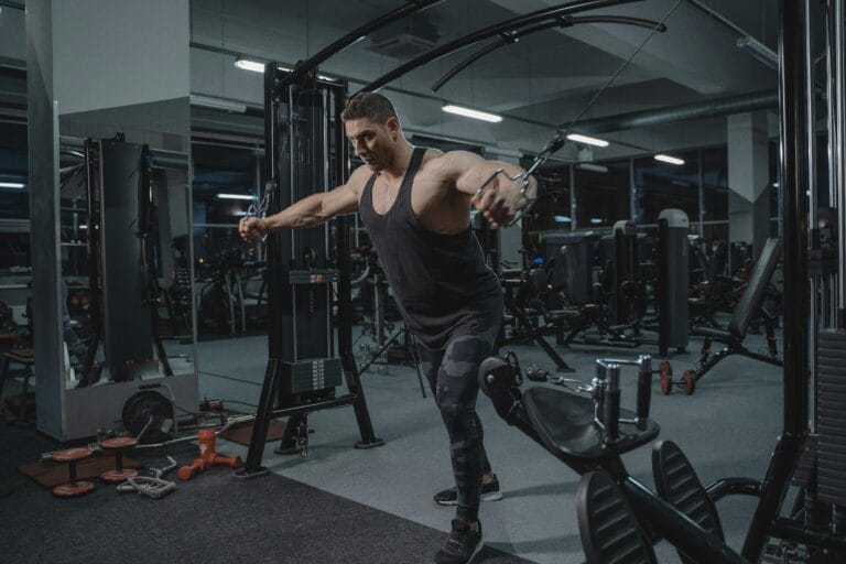 A Man Using the Cable Crossover Machine at the Gym