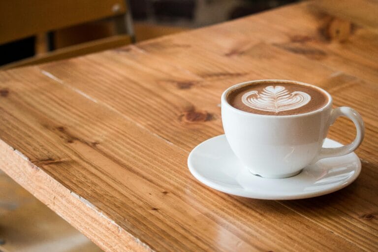 Close-up photograph of a cup of coffee, showcasing the rich texture and color of the brew.